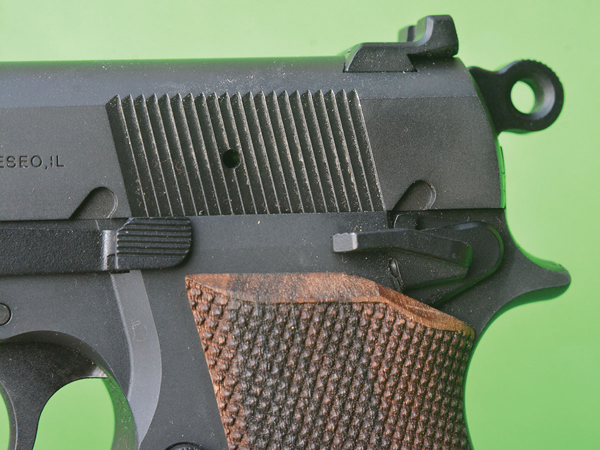 The safety is larger than on early FN Hi-Power pistols and the grip is designed to prevent pinching the web of the hand.
